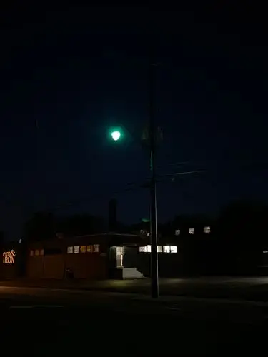 Green light glows in the quiet urban night.